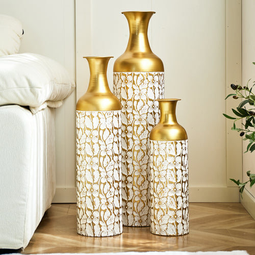 Set of three gold and white metal floor vases