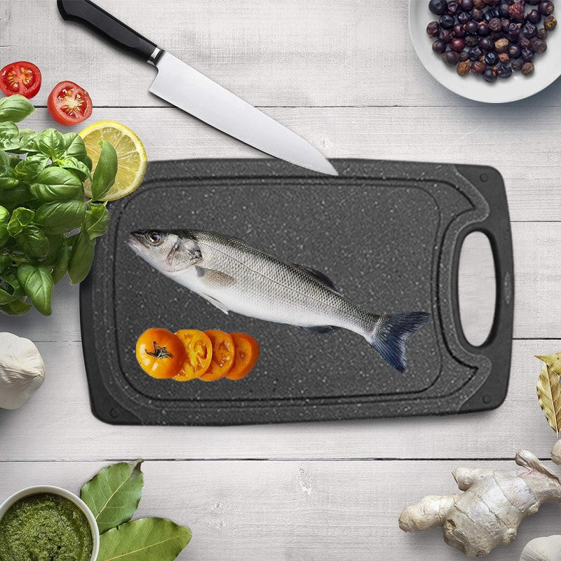 Chopping board with fresh fish and vegetables